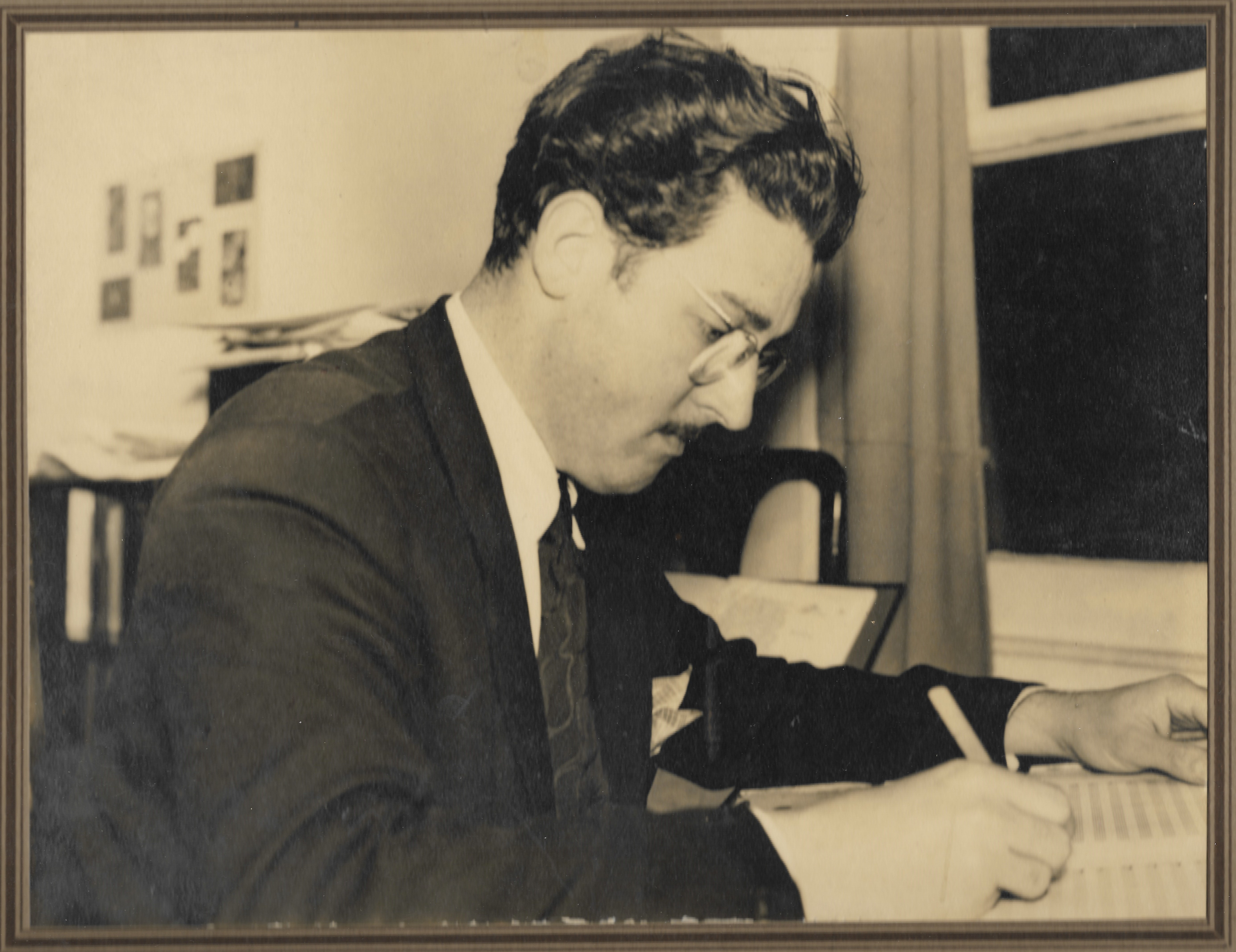 Leonard Salzedo, age 40, composing at his desk in London. Sepia image.