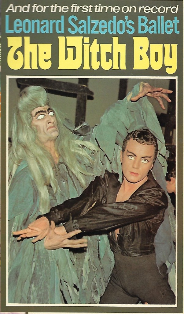 Photo of ballet dancers, one a 'Conjurman' in grey wig and grey costume, the other a 'witch boy' in black and looking at the camera
