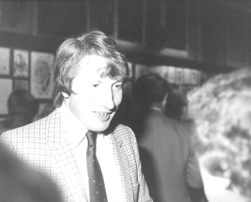Black and white image over the shoulder at a party